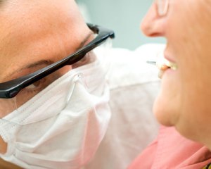 dentist performing denture reline exam