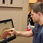 Dr. Wilson zooming in on an image on a monitor