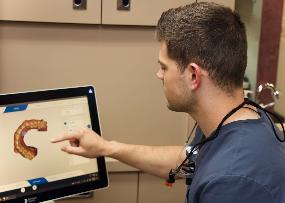 Dr. Wilson examining dental images on a monitor