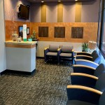 Comfortable waiting room with blue upholstered chairs and carpeted flooring